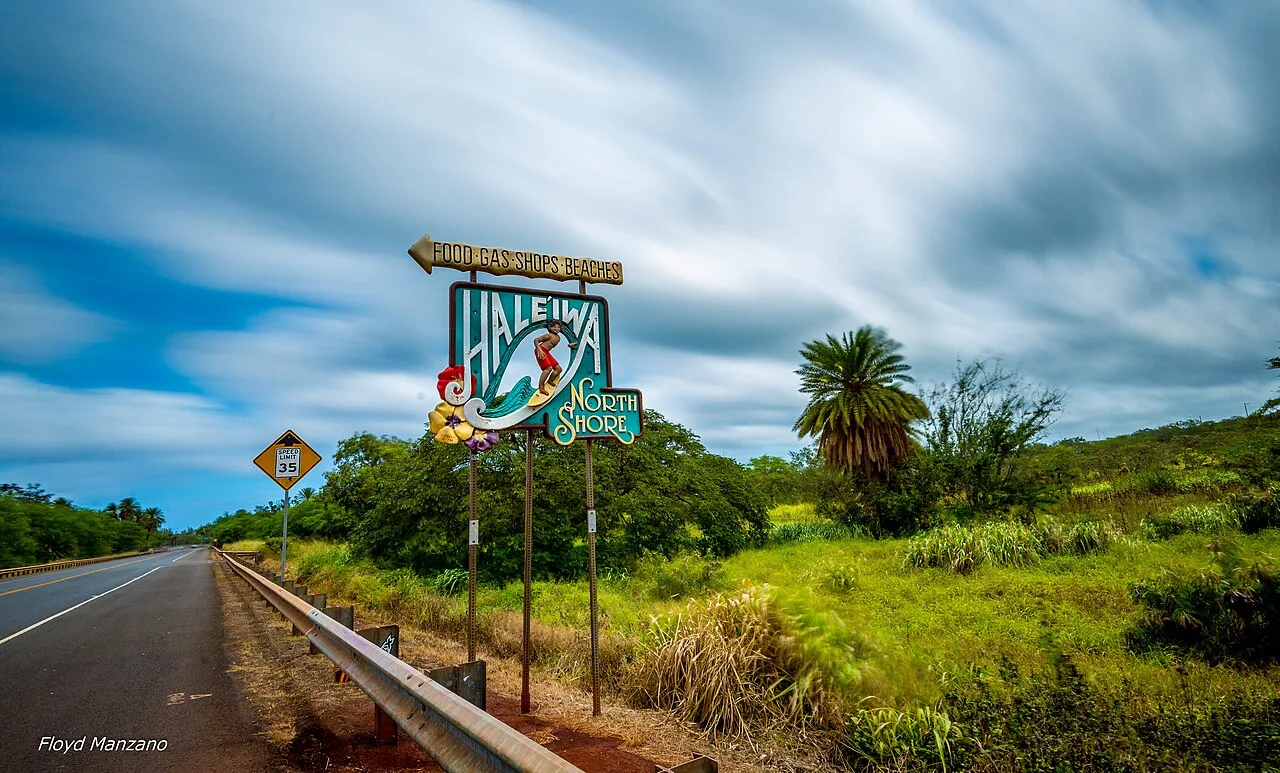 Colorful Haleʻiwa North Shore roadside sign beneath a blue sky