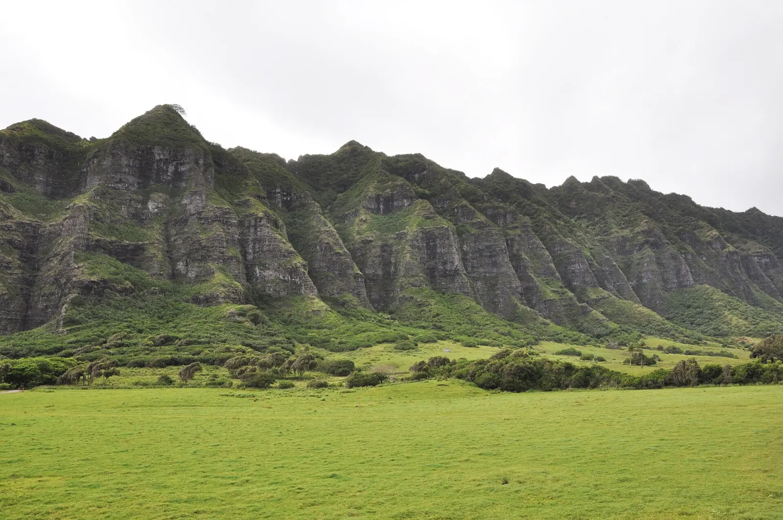 The dramatic green mountain ridges and open valley at Kualoa Ranch
